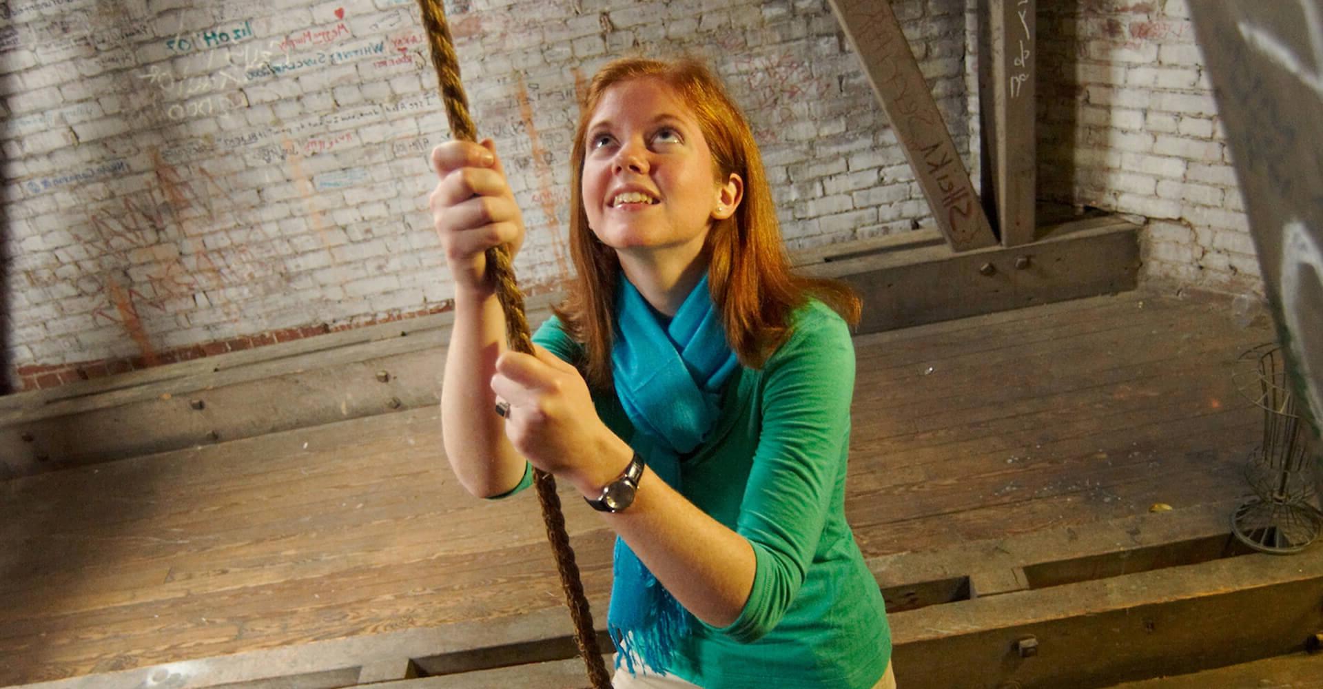 a female student ringing the bell